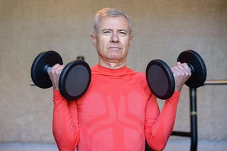 older man lifting weights to help maintain testosterone levels