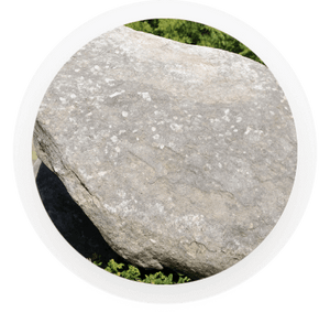 a rock sitting on green grass