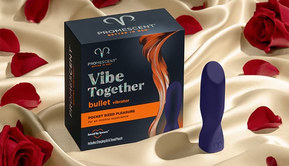 Promescent bullet vibrator and product box on silk sheet with rose petals on it