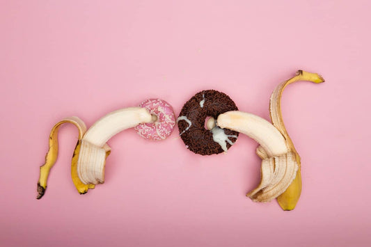 bananas creaming on donuts to simulate ejaculation
