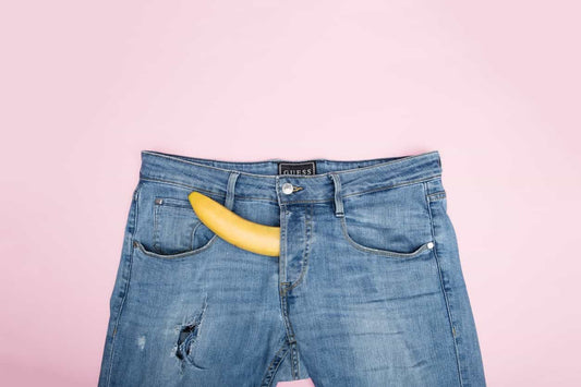 Banana sticking out of zipper of jeans