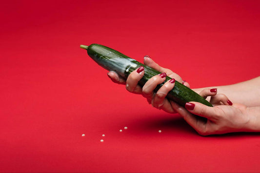 Woman hands holding a cucumber