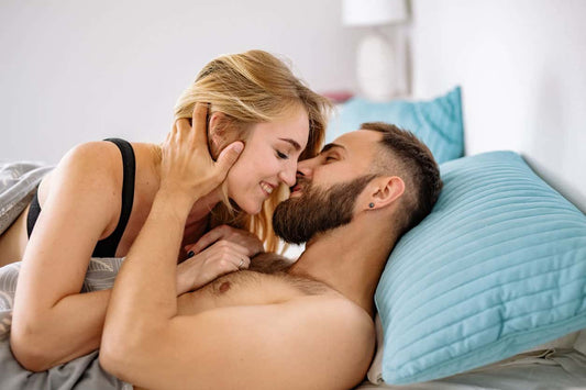 Man and Woman kissing in bed