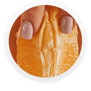 Womans fingers caressing and orange