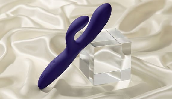 Promescent rabbit vibrator on a white silk sheet